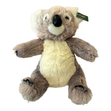 Cuddly grey koala plush toy with a soft cream belly, white inner ears, black nose, and friendly embroidered face.