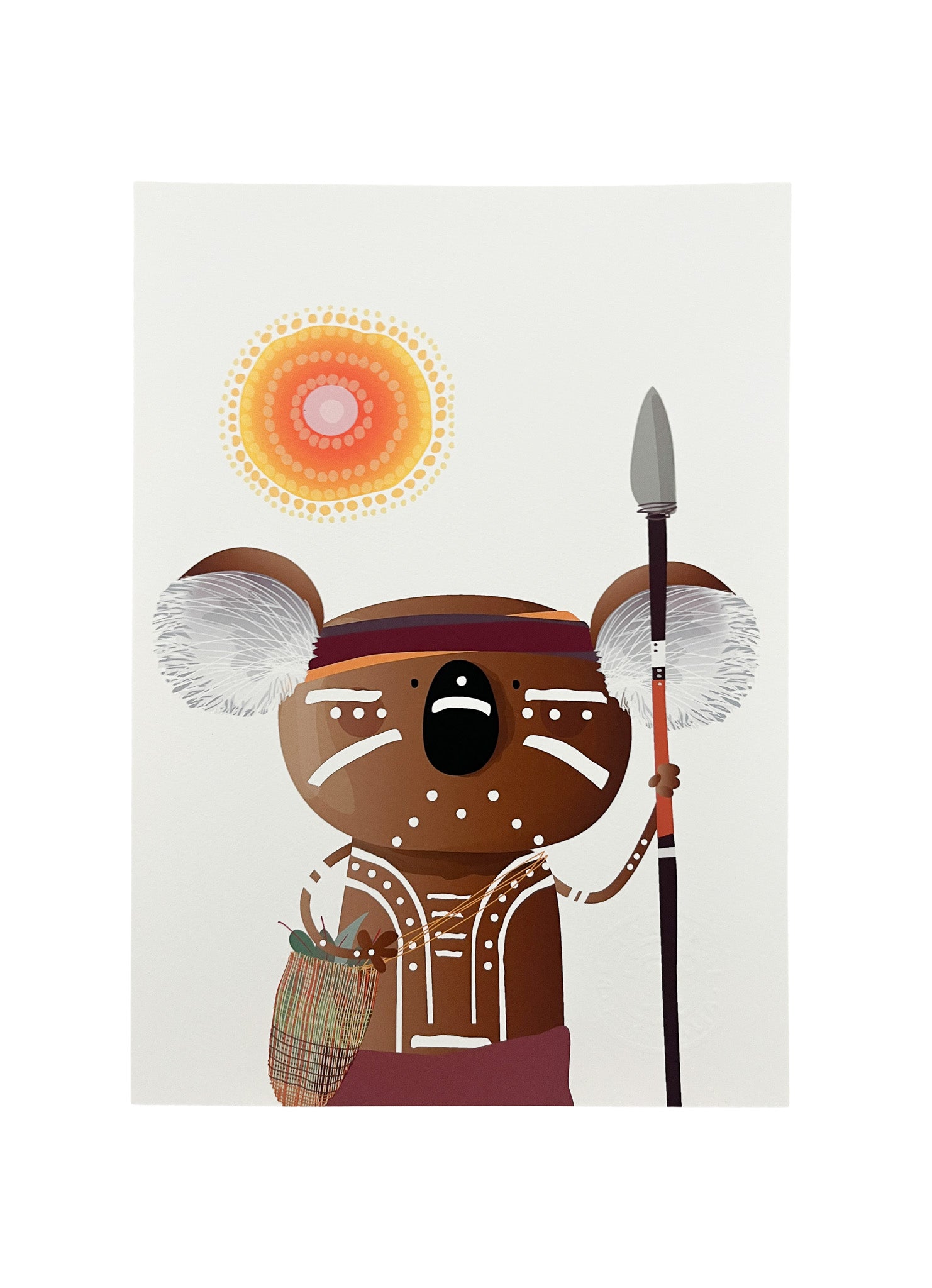 A4 art print of a koala with Aboriginal face and body paint, carrying a spear, dilly bag, with a sun and a Aboriginal design on a light cream background
