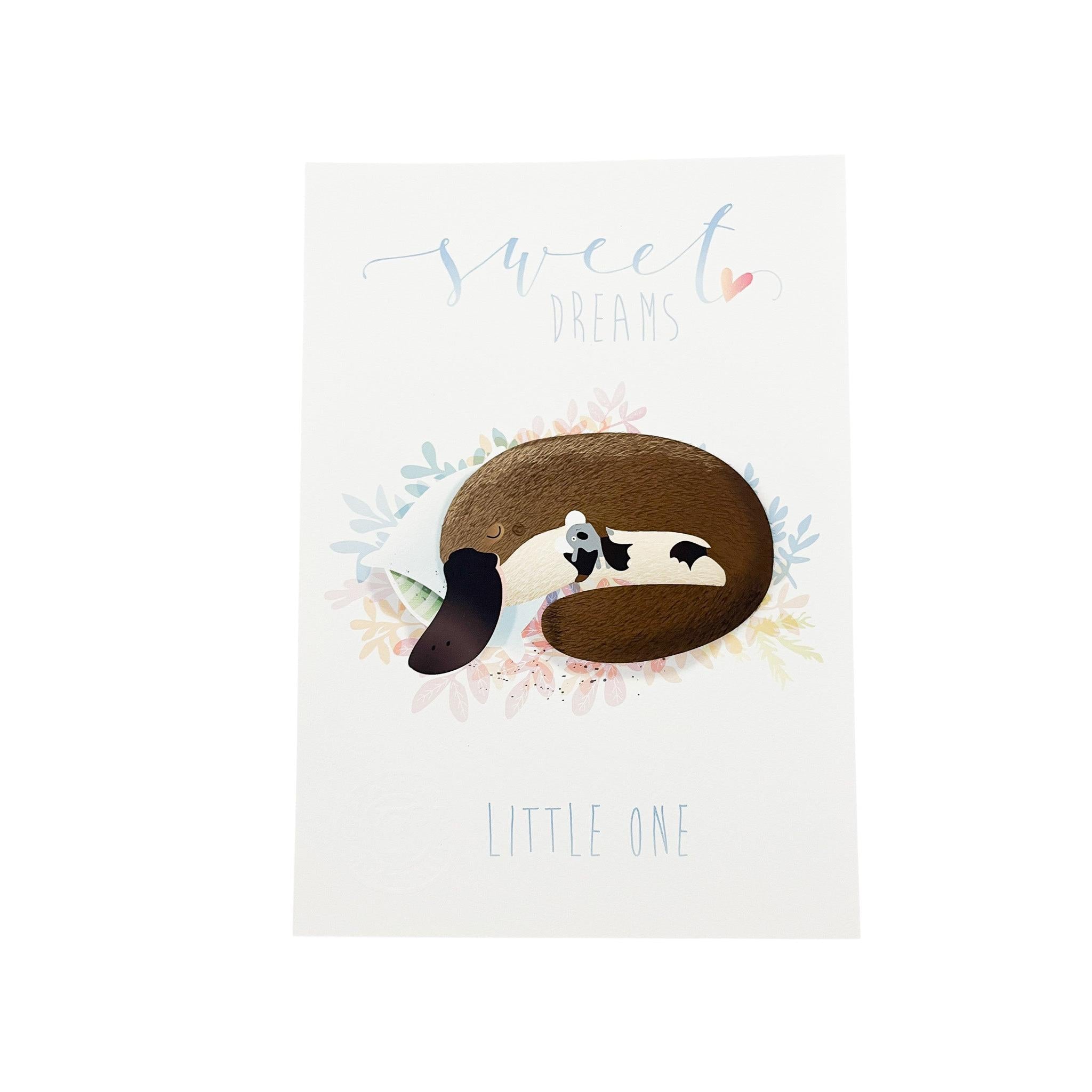A4 art print featuring a sleeping platypus with a koala plush, surrounded by soft pastel leaves and Sweet Dreams text.