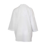 White button down shirt with a circular design on the back against a white background