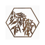 Decorative timber wall art with a golden wattle cut out design in a hexagonal shape on a white background