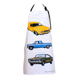 White cotton drill apron with classic Holden cars: yellow 1970s Panel van, blue 1960s Ute, and green HT GTS Monaro Coupe.